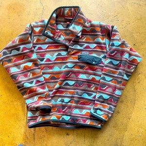 Patagonia pullover sweater with bright blue and orange pattern